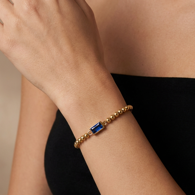 Gold beaded bracelet with a birthstone