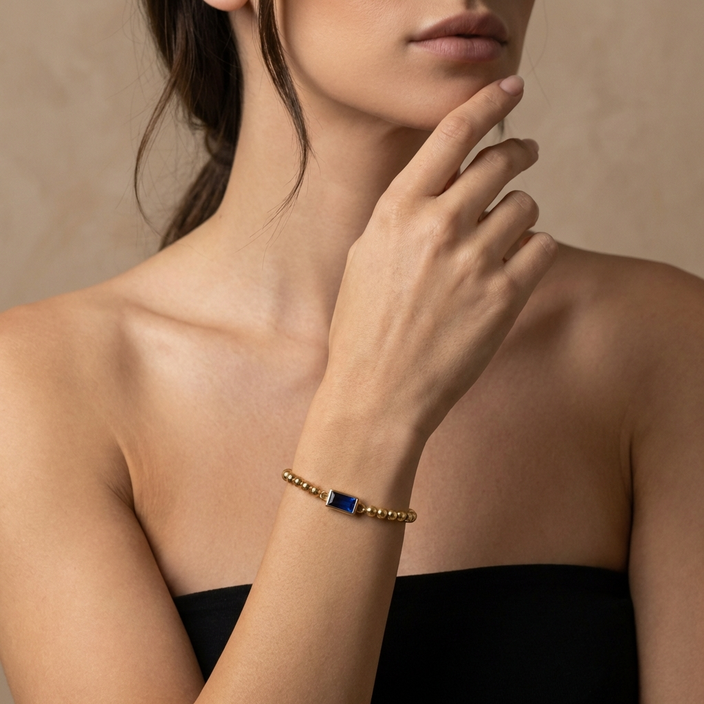 Gold beaded bracelet with a birthstone